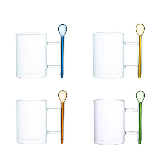Set of clear glass mugs with colored spoons on a white background