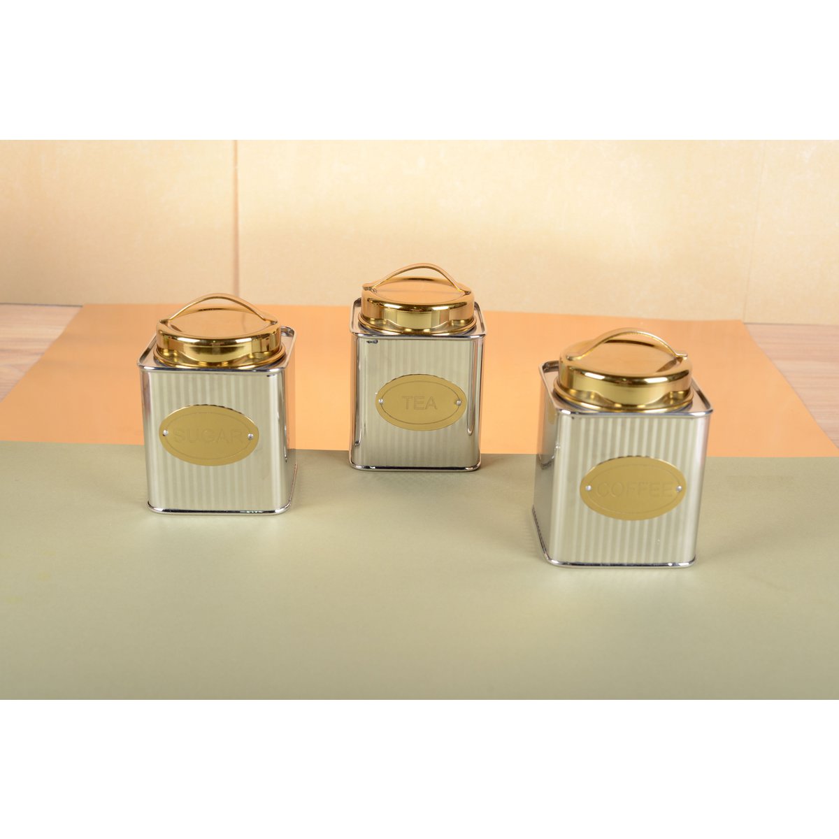 Set of Aulica silver and golden coffee boxes displayed on kitchen counter