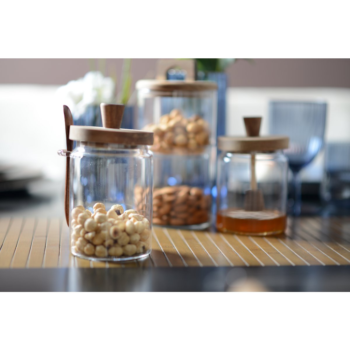 Elegant glass sugar pot with wood lid and spoon perfect for serving or storage