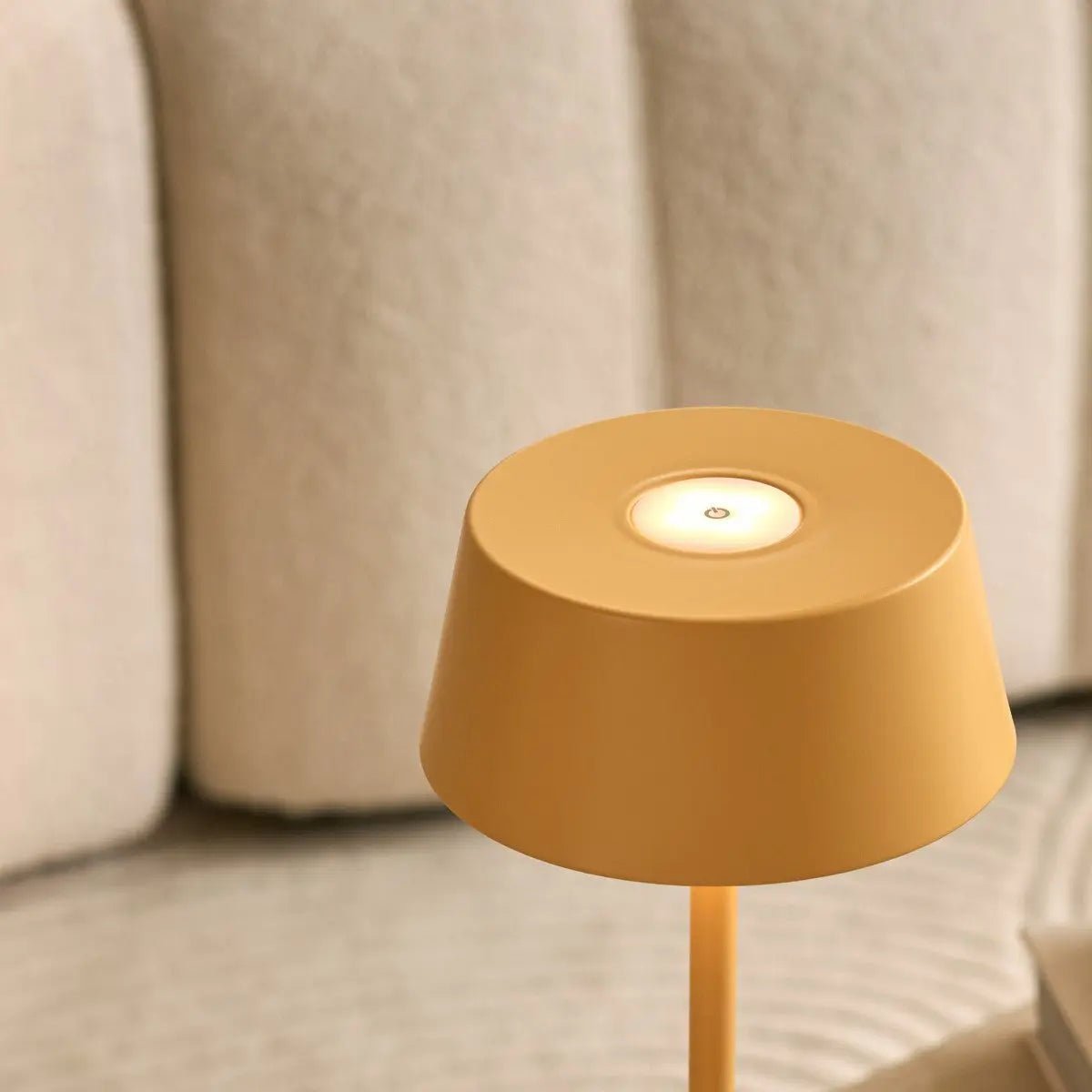 Person adjusting brightness on dimmable Hugo Lamp with touch button