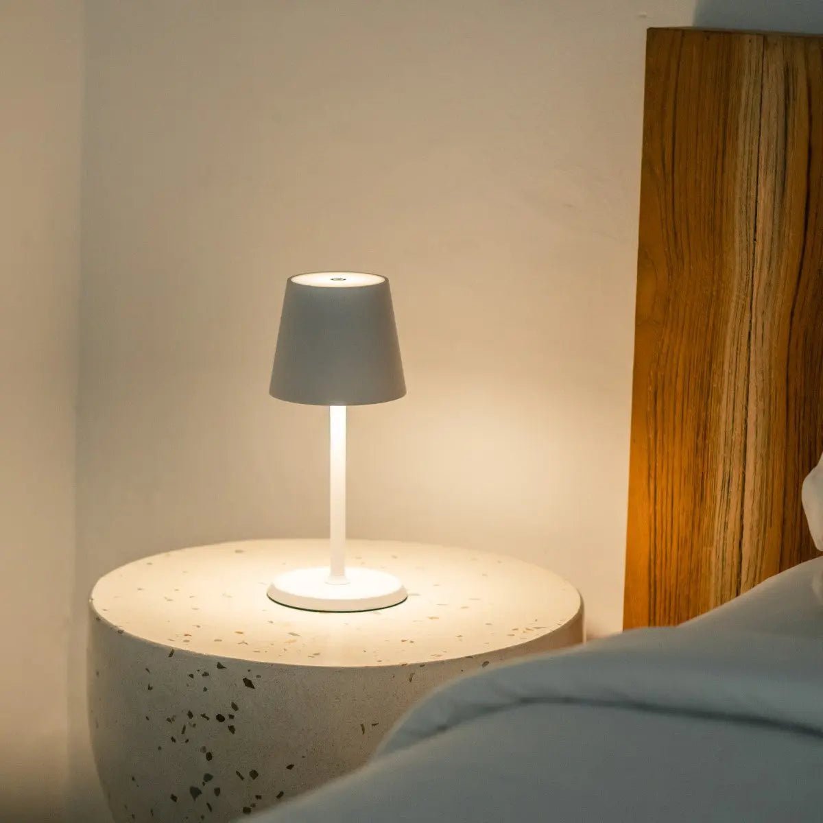 Compact James Lamp offering cordless warm glow beside bed