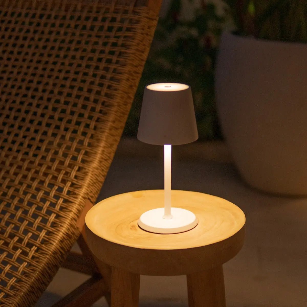 Elegant James Lamp providing warm outdoor cordless light on wooden table