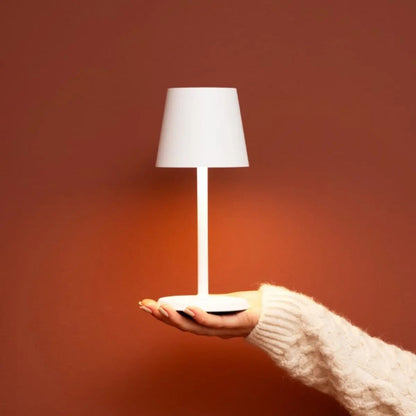 Soft white James Lamp spreading ambient glow in cozy living area