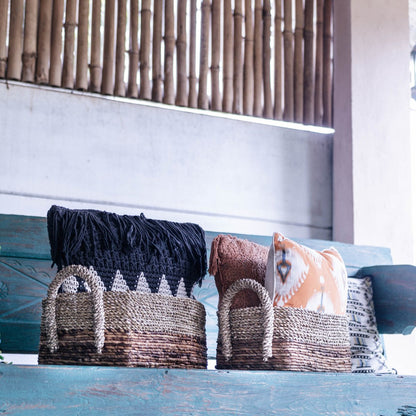 Kapauku woven seagrass and banana fibre basket on wooden bench