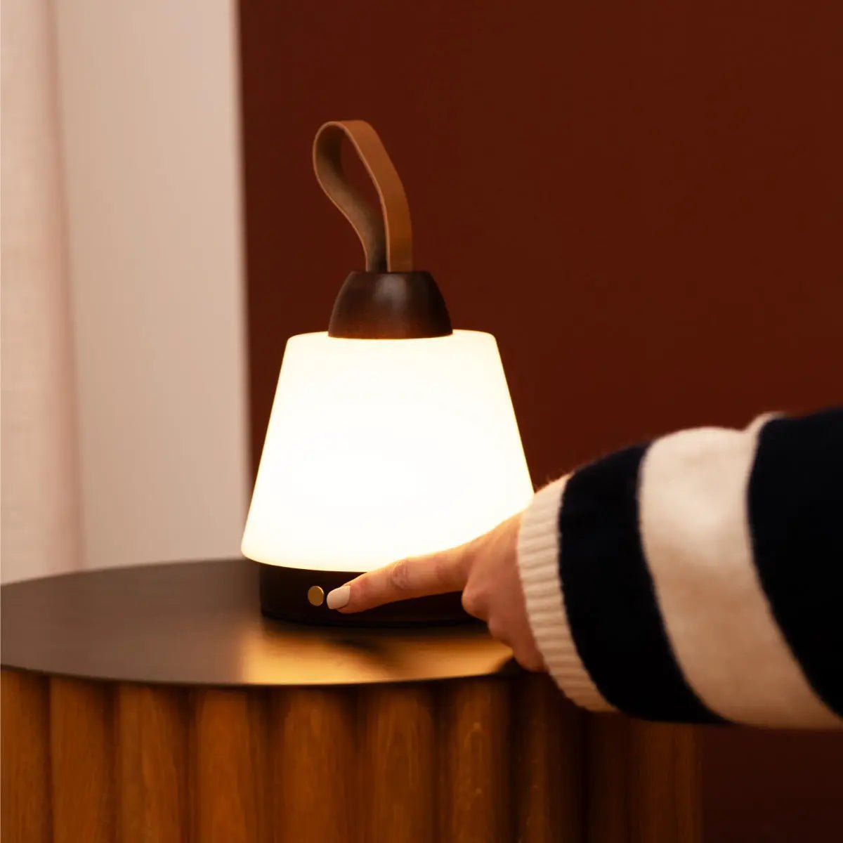 Liv Dark Brown cordless lamp illuminating modern bedside lighting setup