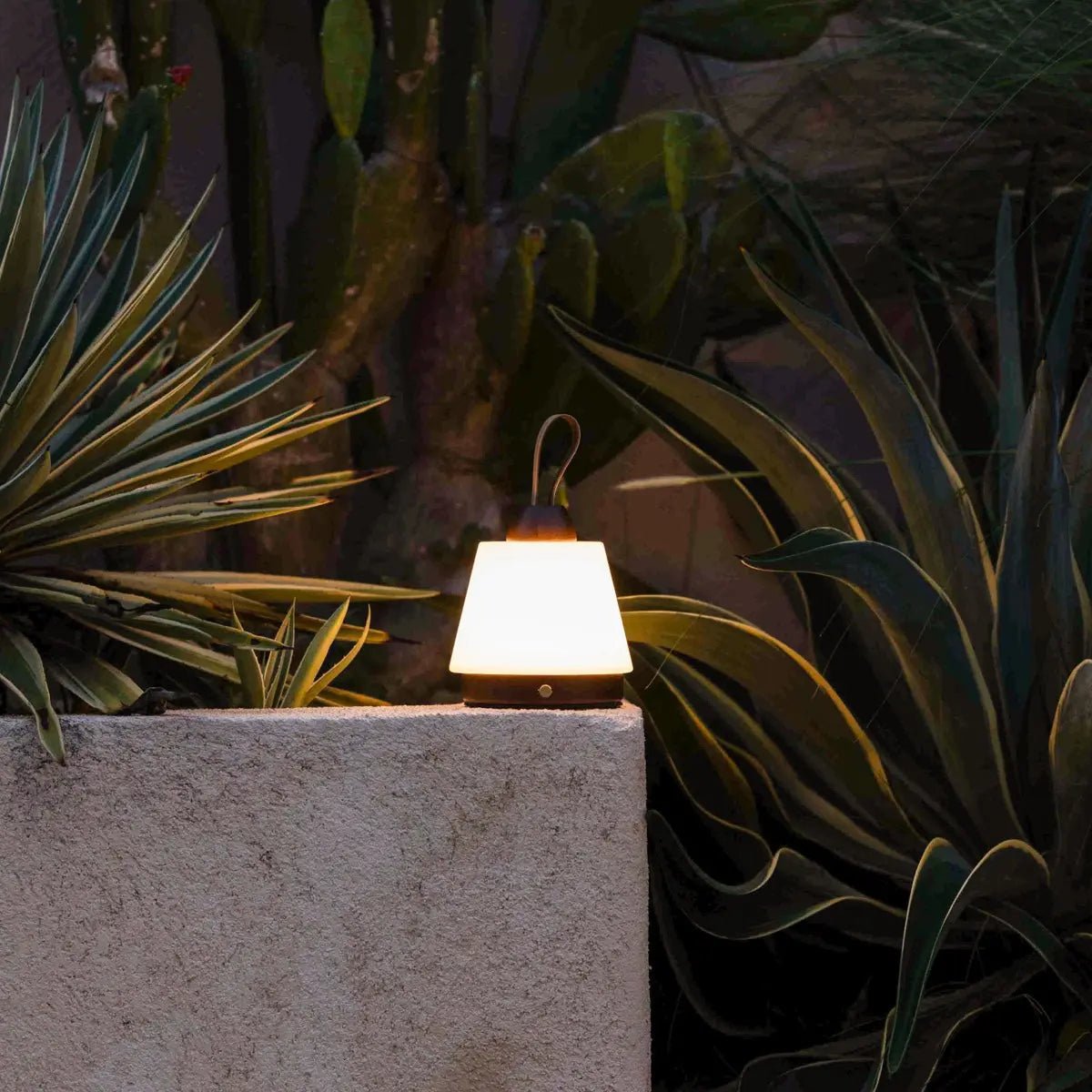 Liv Dark Brown rechargeable lamp creating cozy outdoor evening ambience