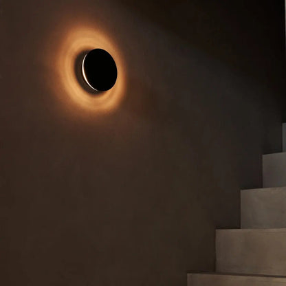 Lou rechargeable wall light giving warm glow in modern hallway