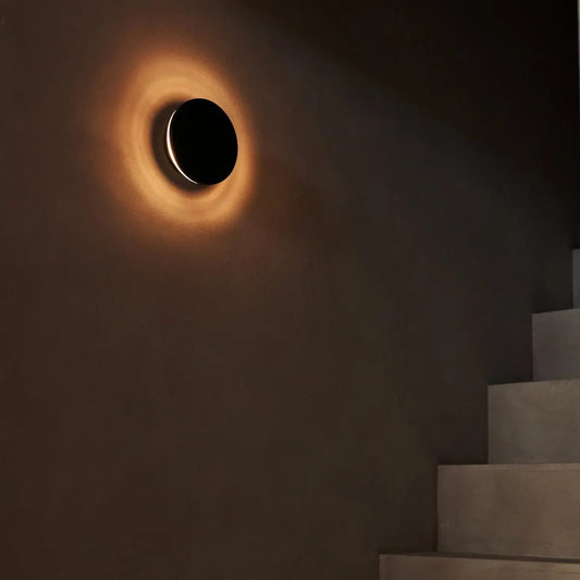 Lou rechargeable wall light giving warm glow in modern hallway