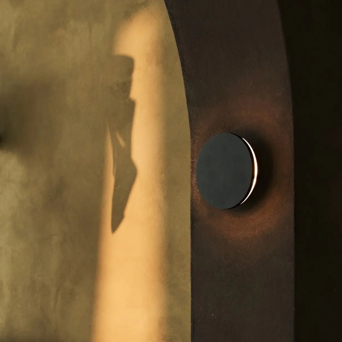 Lou black cordless wall light softly illuminating staircase area