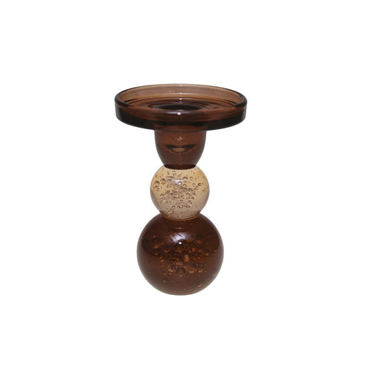 Decorative glass candle holder with three spherical sections on a white background