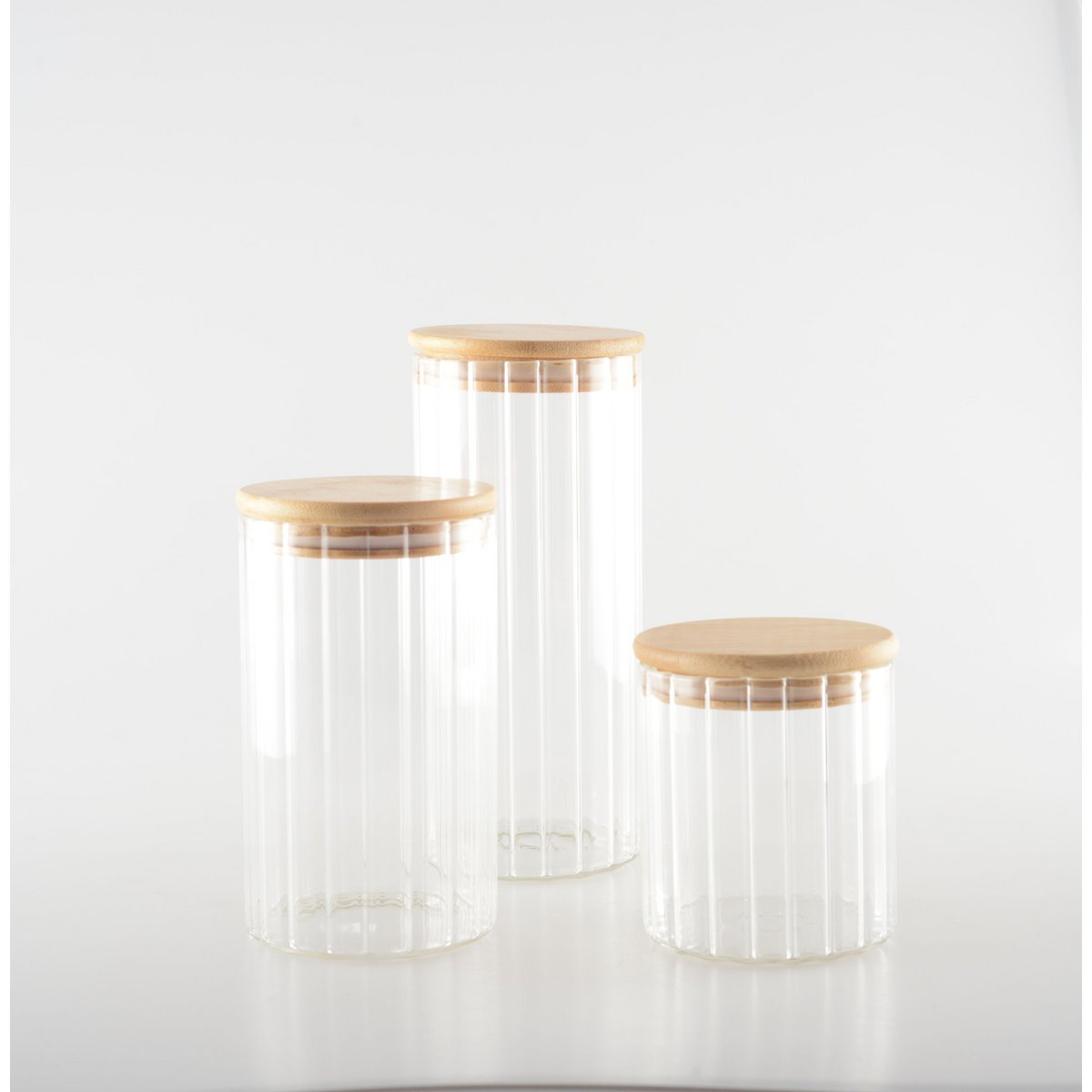 Three glass jars with wooden lids on a white background cosy vibes