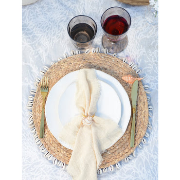 Handwoven rattan placemat with shells for stylish table setup