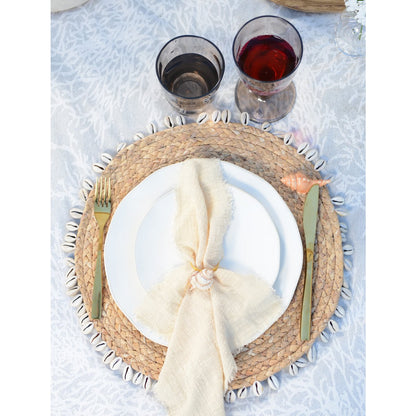 Handwoven rattan placemat with shells for stylish table setup
