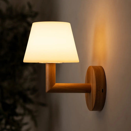 Ted wooden wall lamp glowing softly on textured wall