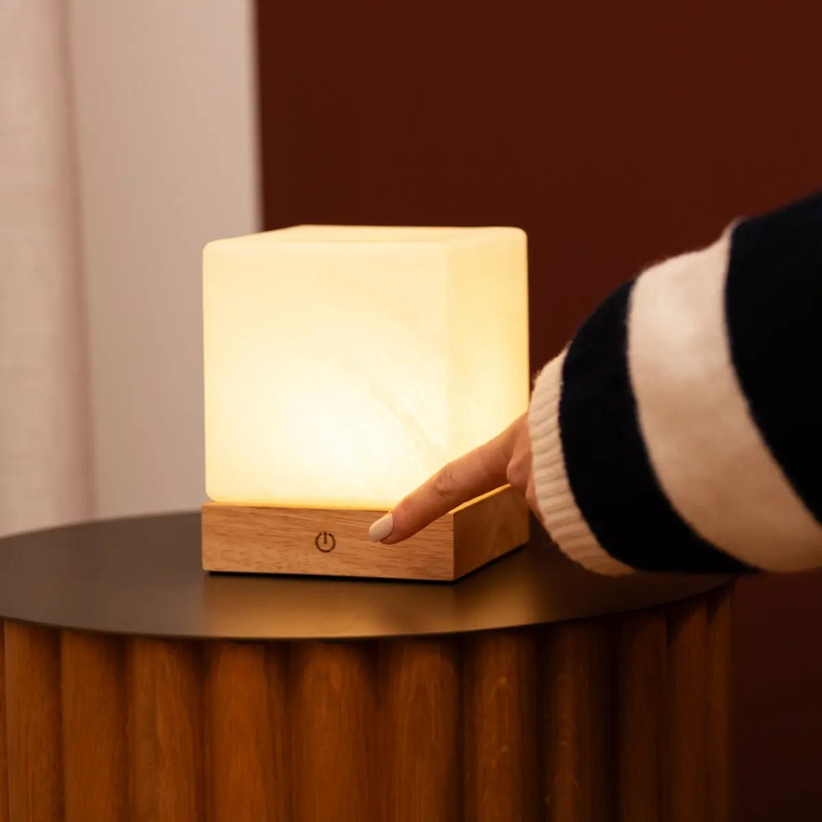 Yce Light Brown cordless wooden lamp glowing softly on round table