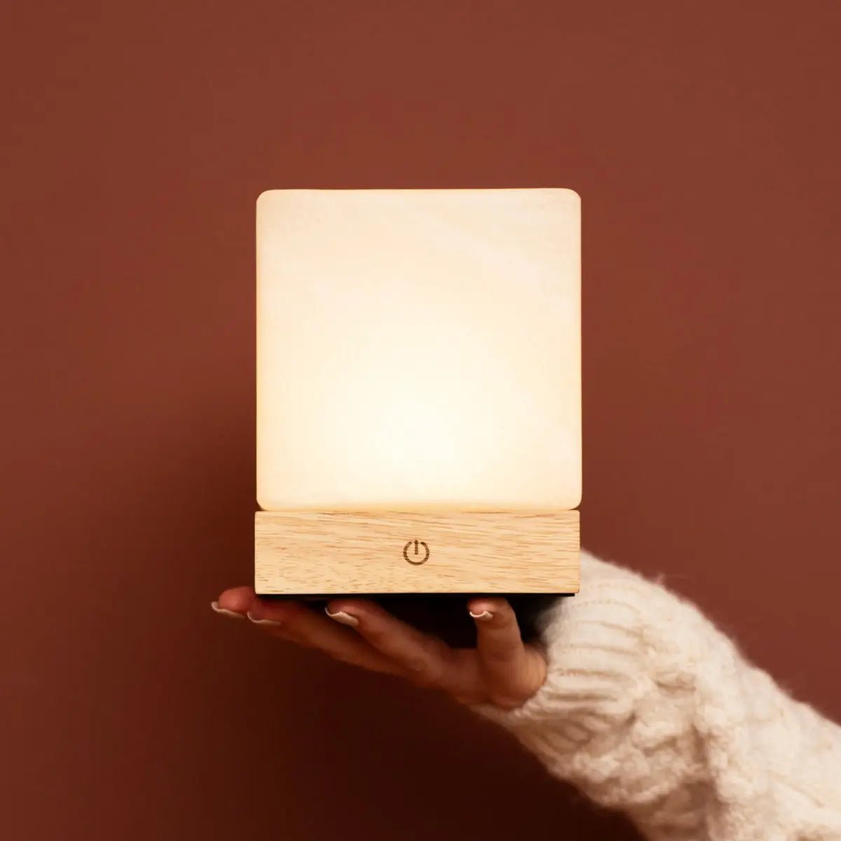Yce Light Brown frozen glass lamp shown in elegant handheld view
