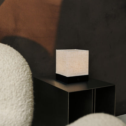 Zano Black wireless lamp softly illuminating a modern bedside table