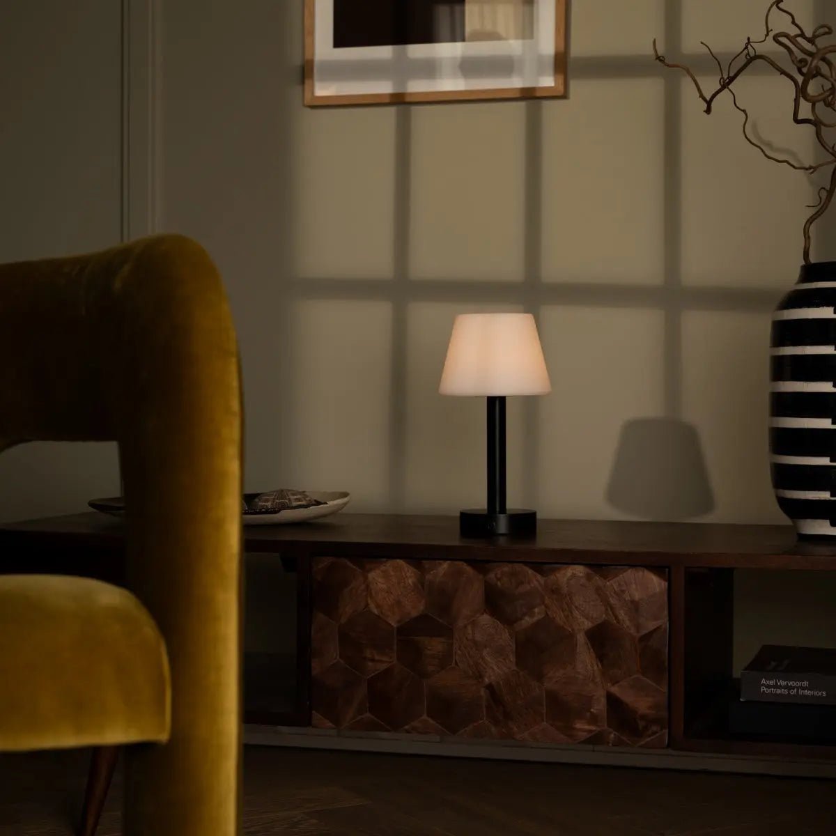 Zoë Black cordless lamp providing warm night light beside sofa