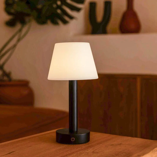 Zoë Black wooden rechargeable lamp glowing softly on wooden table