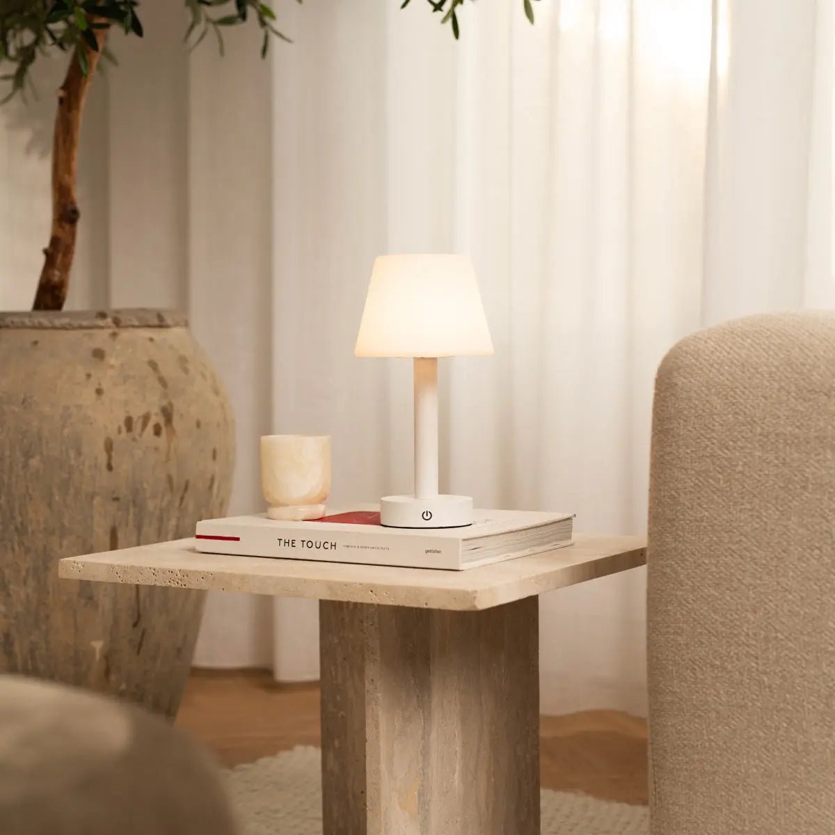 Zoë White wooden lamp softly lighting up bedroom side table