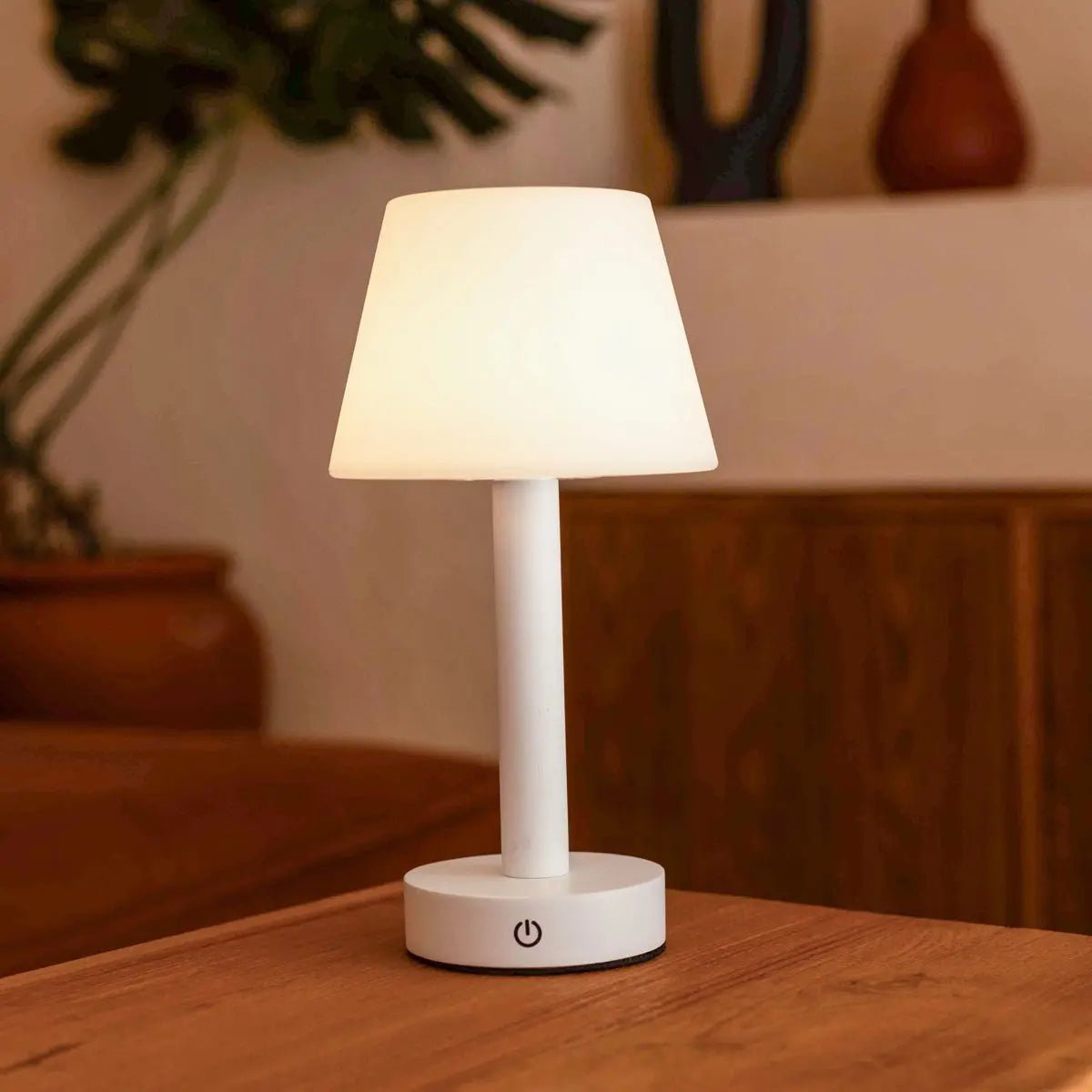 Zoë White wooden rechargeable lamp glowing softly on wooden table