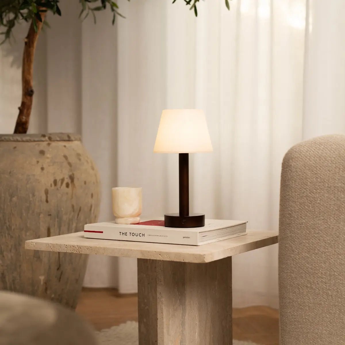 Zoe Dark Brown Wooden Lamp providing warm light on nightstand