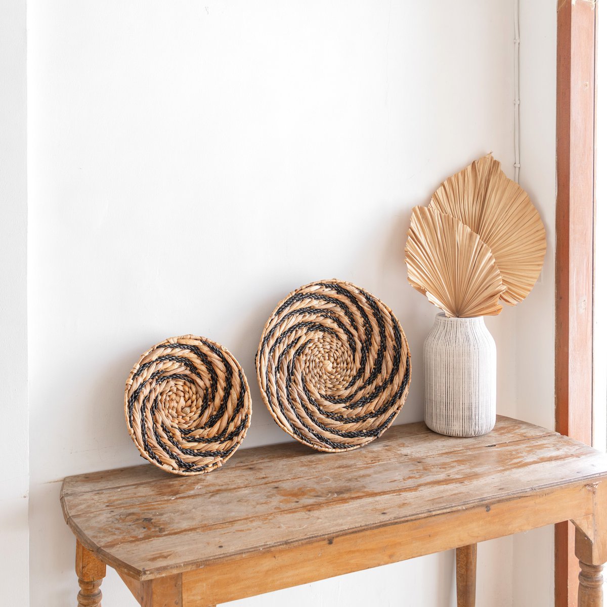 Bandung round water hyacinth basket with black pattern wall art