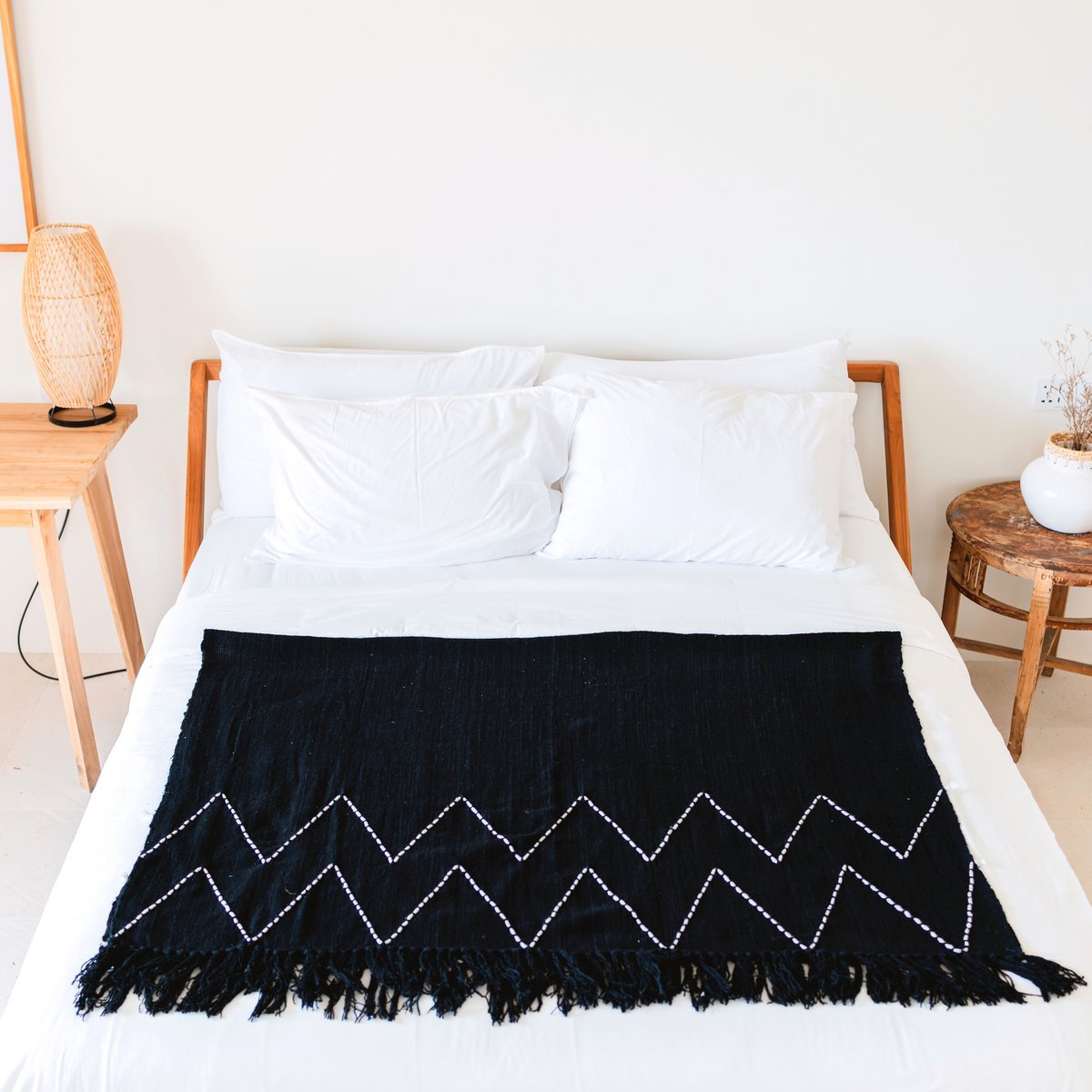 Black Handwoven Boho Cotton Blanket with Fringes on white bed