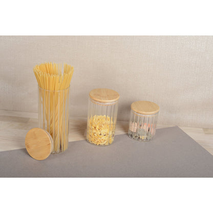 Transparent glass jar with wooden lid for storing dry foods