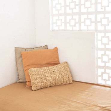 Raffia basket cushion for stylish living room arrangement