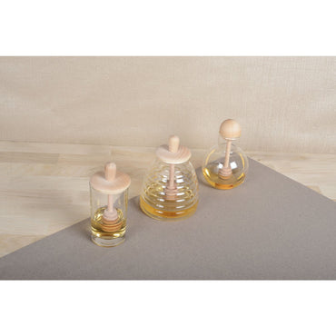 Stylish transparent honey jar made of glass for serving honey