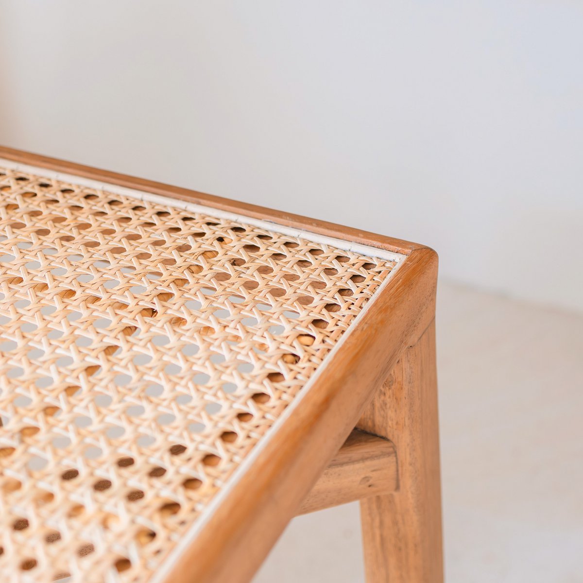 SUBANG wooden basket stool showing natural rattan weave detail